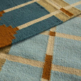 Close-up detail of Blue and Ochre Corbie handwoven wool rug showing grid design.