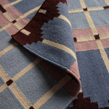 Detail of Pigeon Blue Corbie flatweave wool rug with geometric pattern.