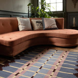 Pigeon Blue Corbie flatweave rug in dusky periwinkle blue styled in a characterful living room.
