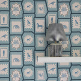 Folk Tales wallpaper in Blue with illustrated animal pattern shown in situ.