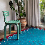 Blue and red hedgerow border rug in living space.