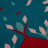 Detail of blue and red Hedgerow border rug handwoven with NZwool.