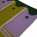 Detail of handwoven green and purple ladder runner rug