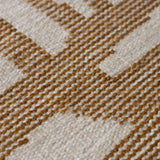 detail of handwoven mustard tudor flatweave rug made from wool with subtle variations in colour for texture and warmth.