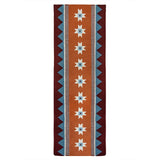 Orange runner rug handwoven from New Zealand wool with a geometric design of star motifs and a blue zig zag border inspired by Victorian tiles.