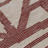 Detail of Red Tudor flatweave rug handwoven with red and natural tones in an artisanal graphic pattern.