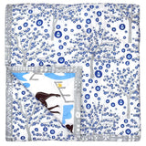 Reversible baby quilt with blue and white Evil Eye tree pattern.