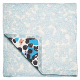 Reverse of the baby quilt with light blue limpet shell print.