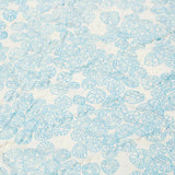 Detail of light blue limpet shell print on Rockpool Baby Quilt