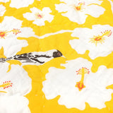 Detail of the Yellow Weaver Baby quilt handprinted with bird and floral patterns.