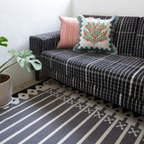 Black and white living room with Darjeeling black and white stripe flatweave rug.