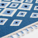 Detail of Blue Evil Eye Flatweave Wool Rug with tassel edge