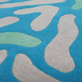 Detail of the Blue and Green Lagoon rug with hand carved abstract wool motifs.