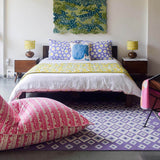 Colourful bedroom with purple lavender Evil Eye flatweave wool rug