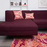 Living room with vibrant Orange Big Cat Camo Rug with burgundy sofa and orange red big cat camo cushions.