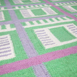 Detail of the Green Labourdonnais Rug handwoven with a checkered grid pattern.