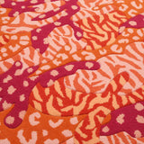 Detail of Orange Big Cat Camo Rug hand tufted and hand carved wool with camouflage and animal print patterns.