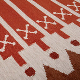 Detail of Rust Darjeeling Rug handwoven in warm shades of red, orange and brown.