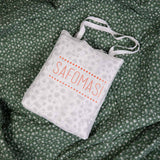 Green Pine Baby Quilted Blanket in an embroidered cotton gift bag.