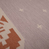 Detail of Manali flatweave stone and terracotta rug in natural earthy tones