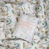 Winding Roads Baby Quilt folded inside embroidered cotton gift bag, ideal for newborn presents