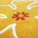 Detail of Yellow Hibiscus rug hand tufted with modern floral motifs